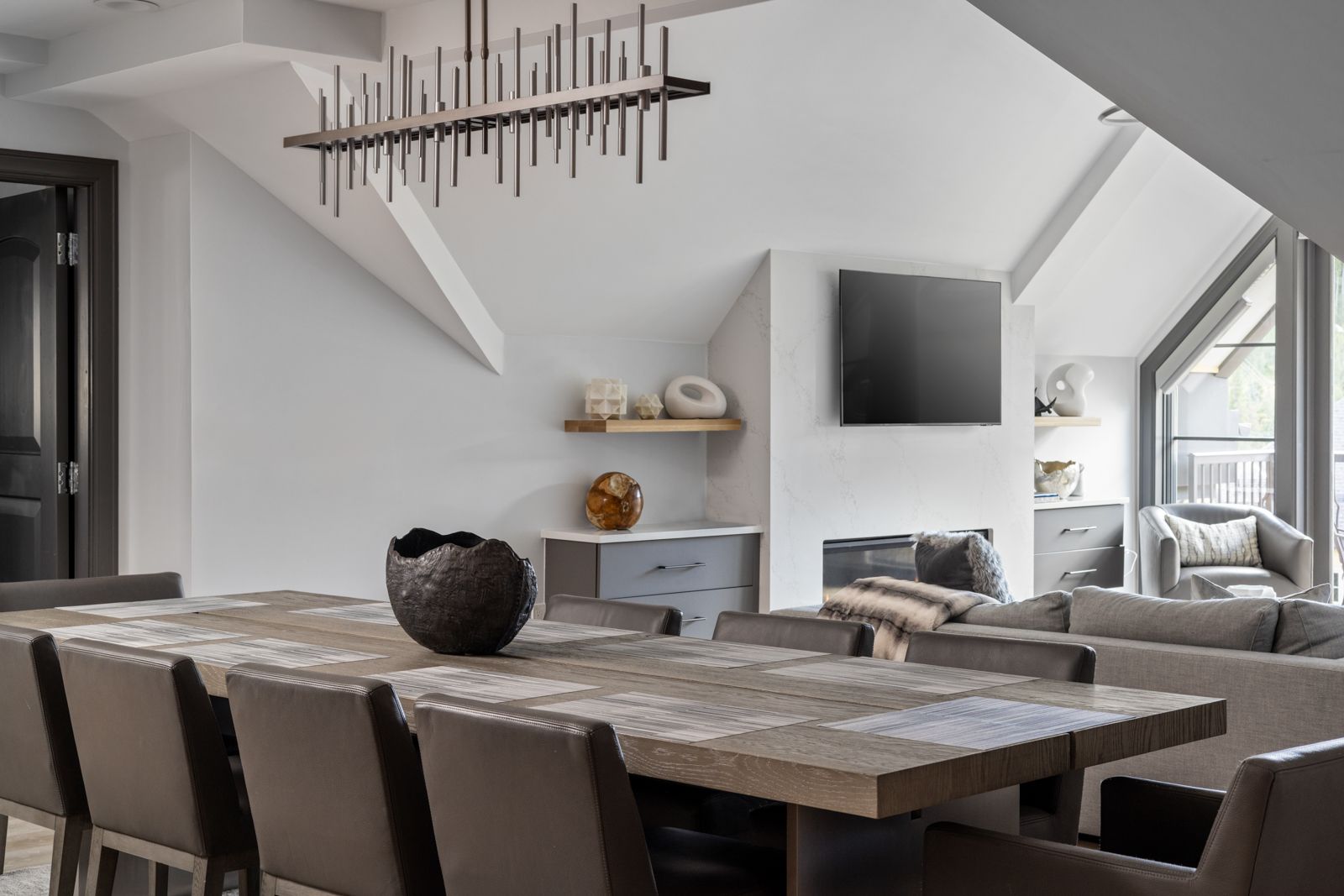 Open-plan penthouse dining and living space with designer chandelier, property video in Mountain Village, Colorado
